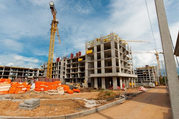 Multi storey concrete frame under construction with tower cranes